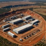 Aerial view of the Zulu Lithium and Tantalum Project site in Zimbabwe, featuring mining equipment and processing facilities surrounded by a rugged landscape.