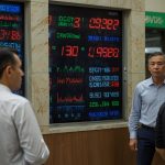A bustling Tashkent currency exchange market with traders and digital boards displaying the USD to UZS exchange rate, reflecting the August 2025 surge.