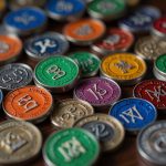 A collection of colorful Narcotics Anonymous sobriety coins arranged on a table, including 24-hour, 30-day, and one-year medallions, symbolizing recovery milestones.