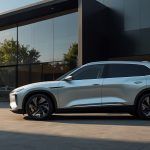 Sleek silver NIO ES8 electric SUV parked in front of a modern NIO House showroom, showcasing its luxurious design and advanced technology, with a vibrant cityscape in the background.