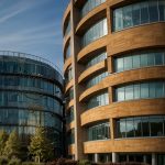 AstraZeneca Cambridge HQ with DNA helix and FTSE 100 chart showing AZN +3.2% surge on oncology data October 29 2025