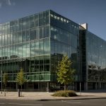 Modern office building of Greencore Group plc in Dublin, Ireland, with glass facade and company logo prominently displayed.