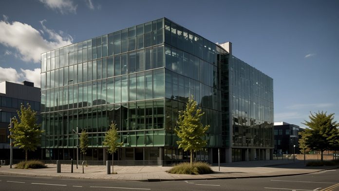 Modern office building of Greencore Group plc in Dublin, Ireland, with glass facade and company logo prominently displayed.