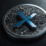Official XRP cryptocurrency coin logo in silver with blue X symbol, representing fast cross-border payments and Ripple network utility amid 2025 market surge