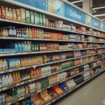 Vibrant display of Unilever's iconic brands like Dove, Ben & Jerry's, and Knorr on supermarket shelves with shoppers in the background, representing the company's sales surge and share price gains amid resilient consumer demand for 2025