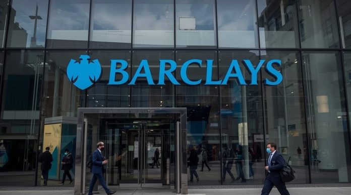 Barclays headquarters at One Churchill Place in Canary Wharf, London, with the Barclays logo prominently displayed against a clear blue December sky as the bank’s share price climbs 1.6% following positive Bank of England stress test results on 3 December 2025.