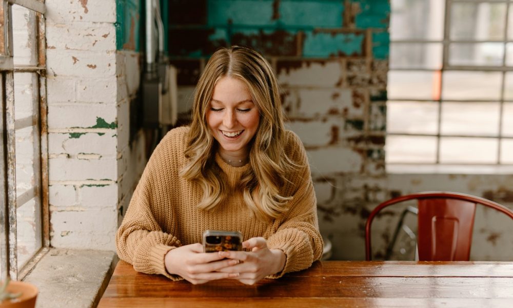 Borrower checking a loan account on a smartphone: Borrower Support Matters Long After a Loan Is Approved
