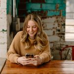 Borrower checking a loan account on a smartphone: Borrower Support Matters Long After a Loan Is Approved