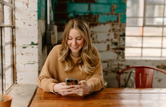 Borrower checking a loan account on a smartphone: Borrower Support Matters Long After a Loan Is Approved