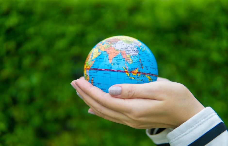 A hand holding a globe representing global business and international communication