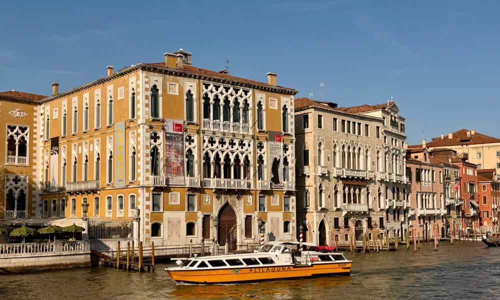 Historic palazzi lining the Grand Canal in Venice as a water bus passes