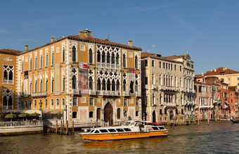 Historic palazzi lining the Grand Canal in Venice as a water bus passes
