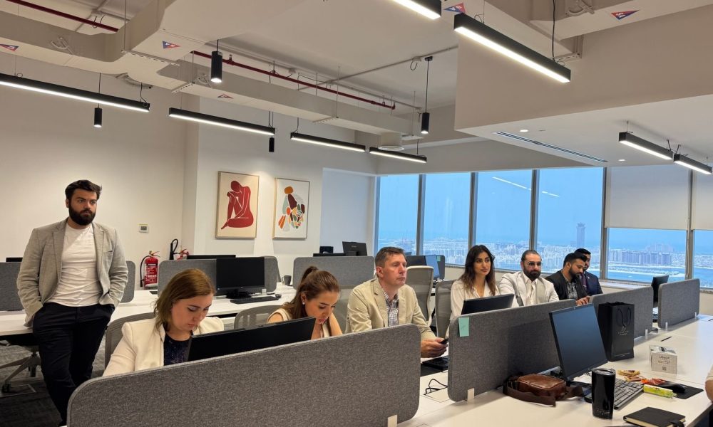 Team working in a modern Dubai office with city views