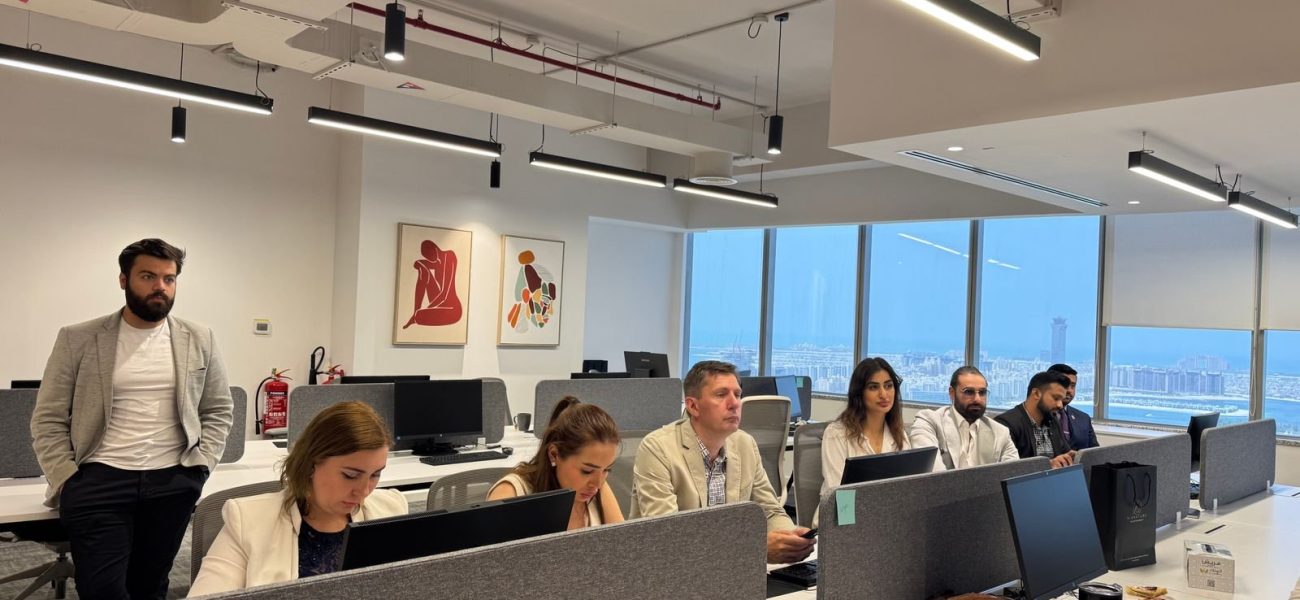 Team working in a modern Dubai office with city views