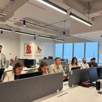 Team working in a modern Dubai office with city views