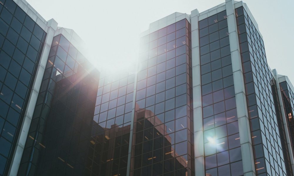 Glass office tower of a major bank reflecting sunlight