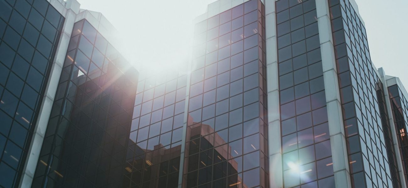 Glass office tower of a major bank reflecting sunlight