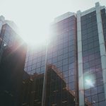 Glass office tower of a major bank reflecting sunlight