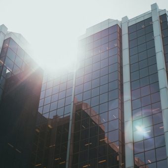 Glass office tower of a major bank reflecting sunlight