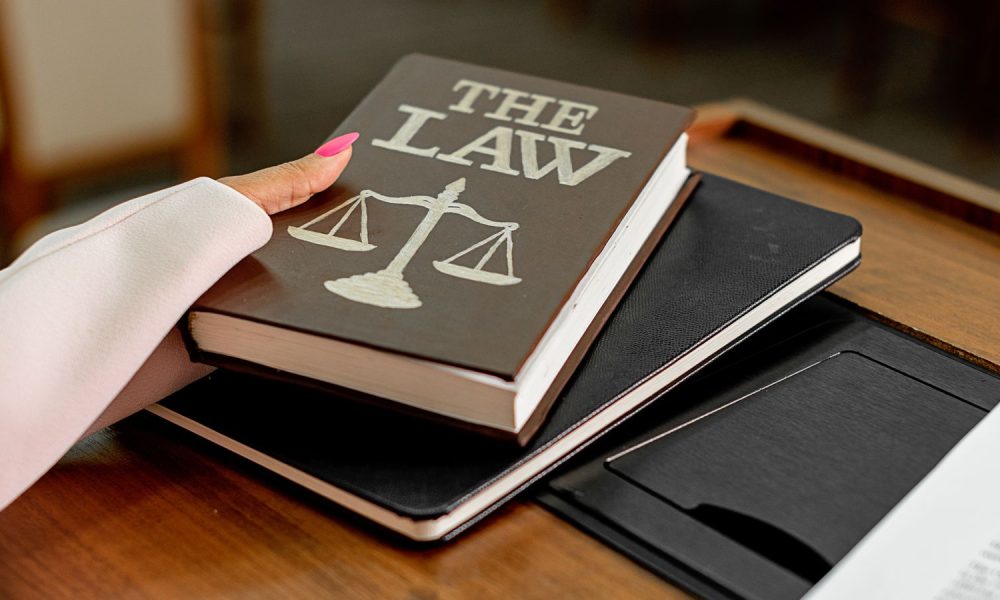 Law book with scales of justice on a lawyer's desk