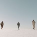 Runners crossing a vast plain of ice and snow, the kind of polar course Great World Race competitors face at Wolf's Fang, Antarctica