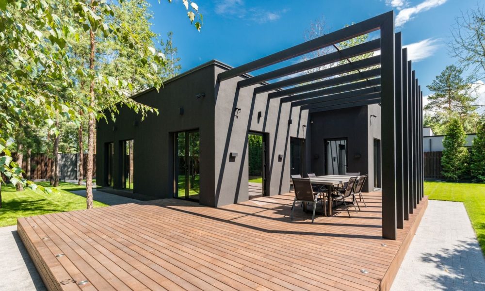 Modern house with a timber deck and outdoor dining area, one of the home improvements that could add value