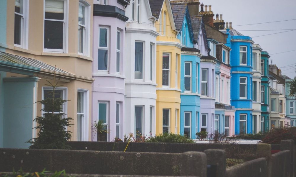A row of colourful terraced houses on a residential street