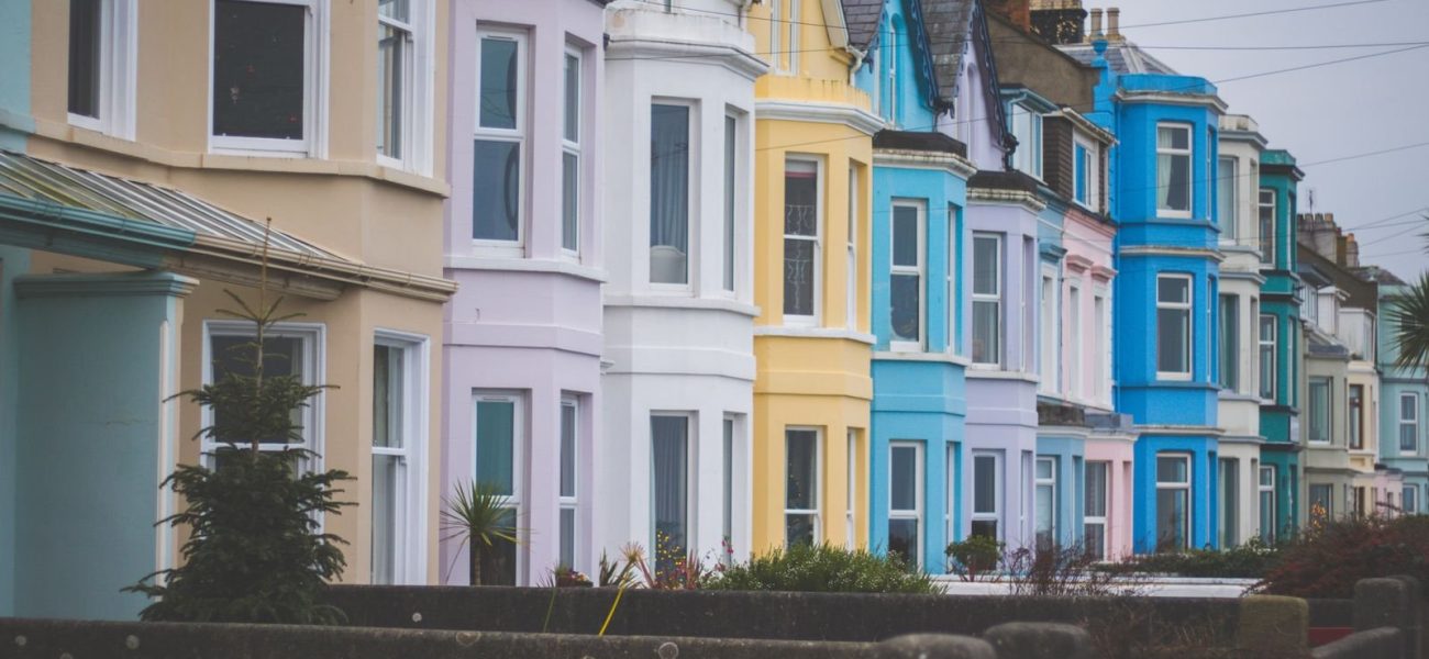 A row of colourful terraced houses on a residential street