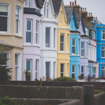 A row of colourful terraced houses on a residential street