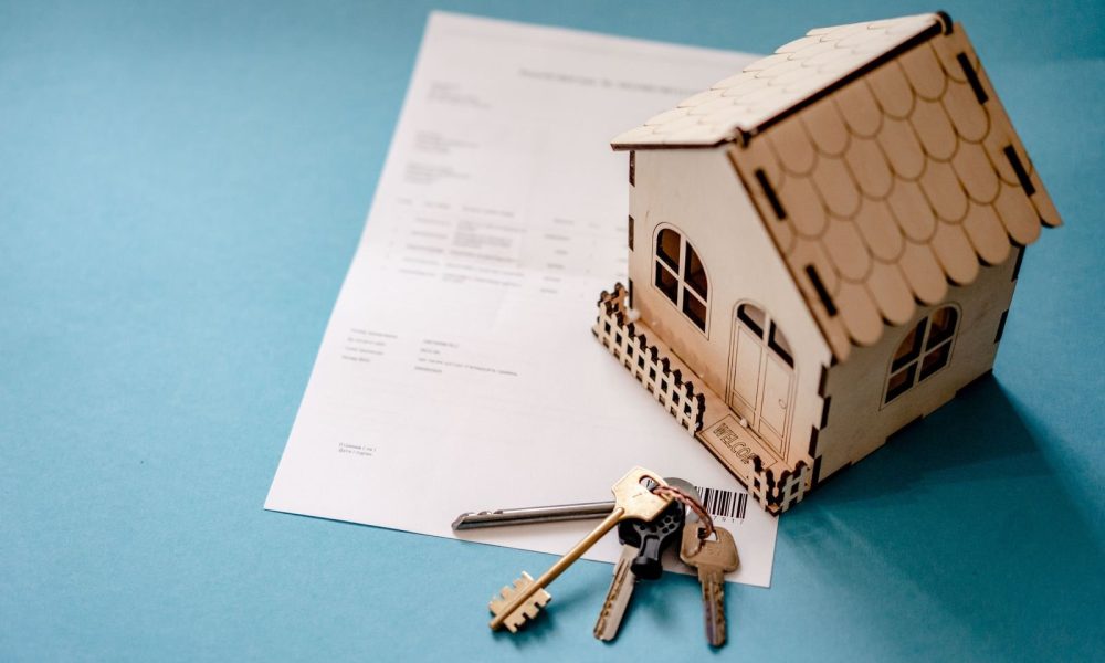 Model house with keys and a property contract