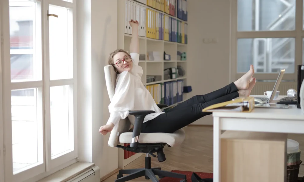 Woman stretching at her desk during a break from screen time