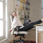 Woman stretching at her desk during a break from screen time