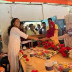 A student receives an education sponsorship from Mujjahid Huq at a ceremony in Bangladesh