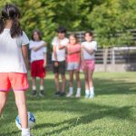 Children taking turns at a relaxed football session, the low-pressure play that supports youth mental wellness