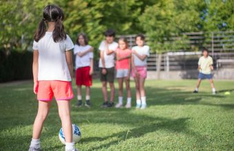 Children taking turns at a relaxed football session, the low-pressure play that supports youth mental wellness